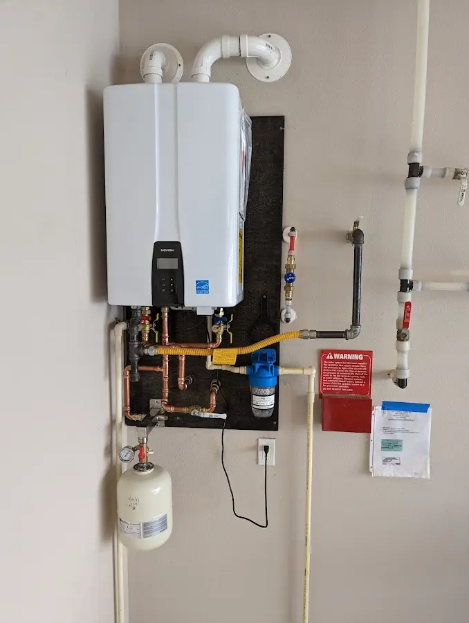 Professional plumber installing copper piping in a Heathrow home